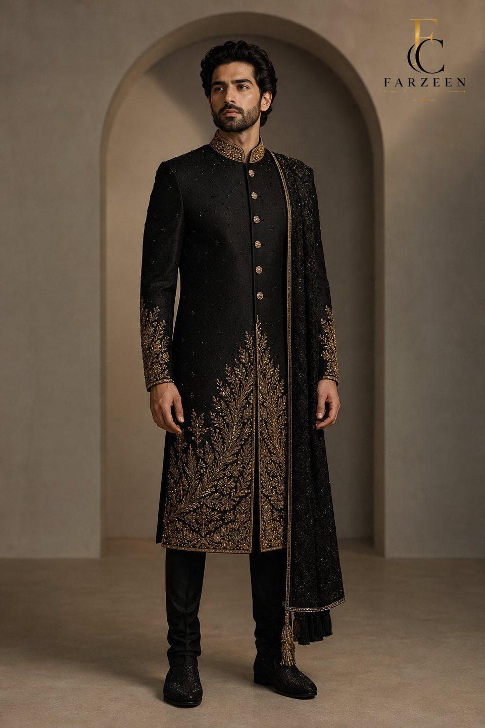 Groom in a black silk sherwani with gold zardozi rising from the hem
