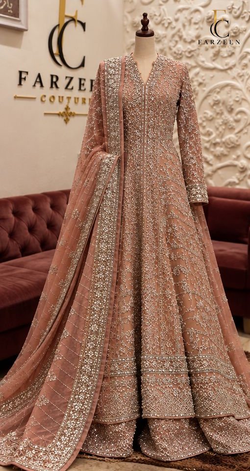 Blush rose jacket lehenga with silver embellishment and sheer dupatta on a mannequin