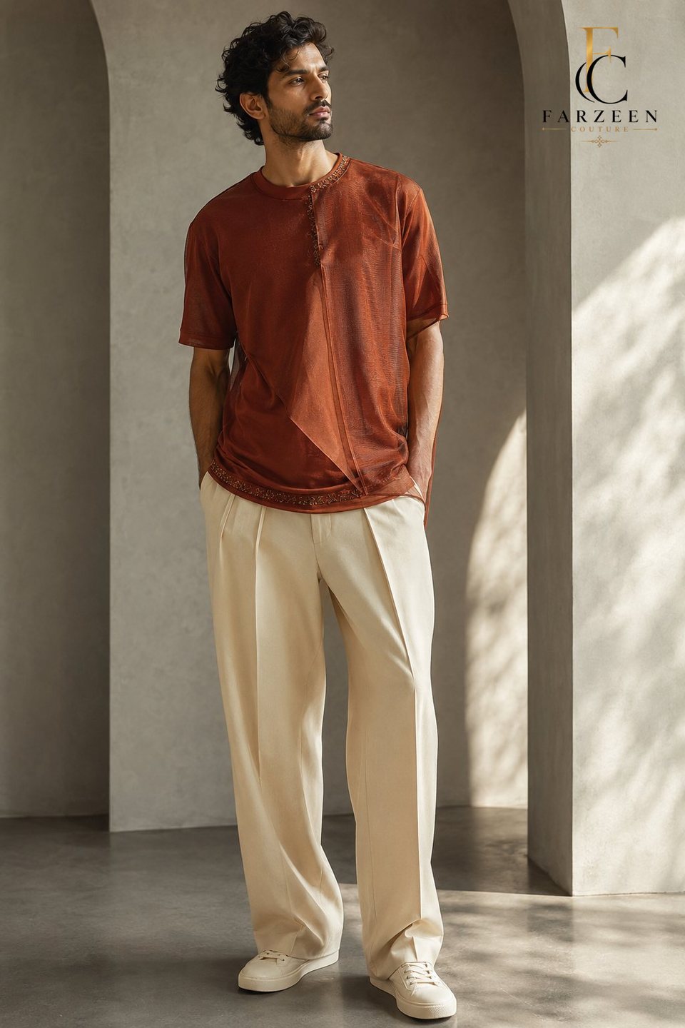Man in a rust layered T-shirt and cream wide trousers