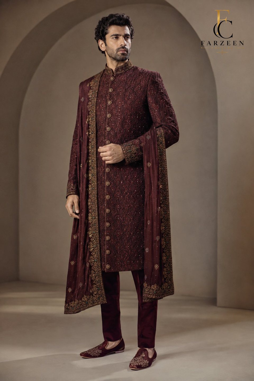 Groom in a maroon silk sherwani with zardozi and an embroidered stole
