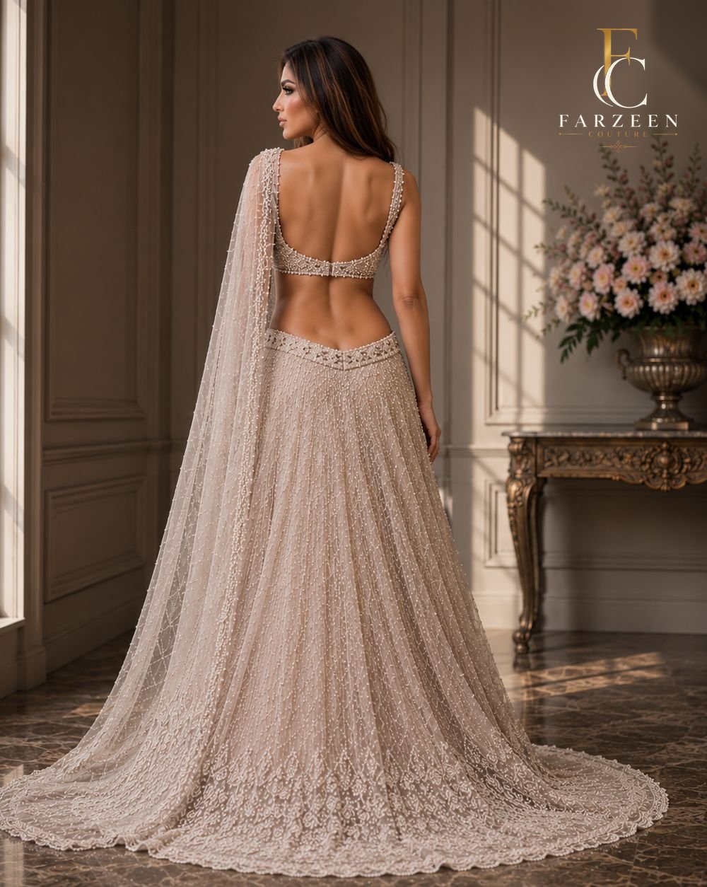 Bride in an ivory lace backless gown with a long train, seen from the back