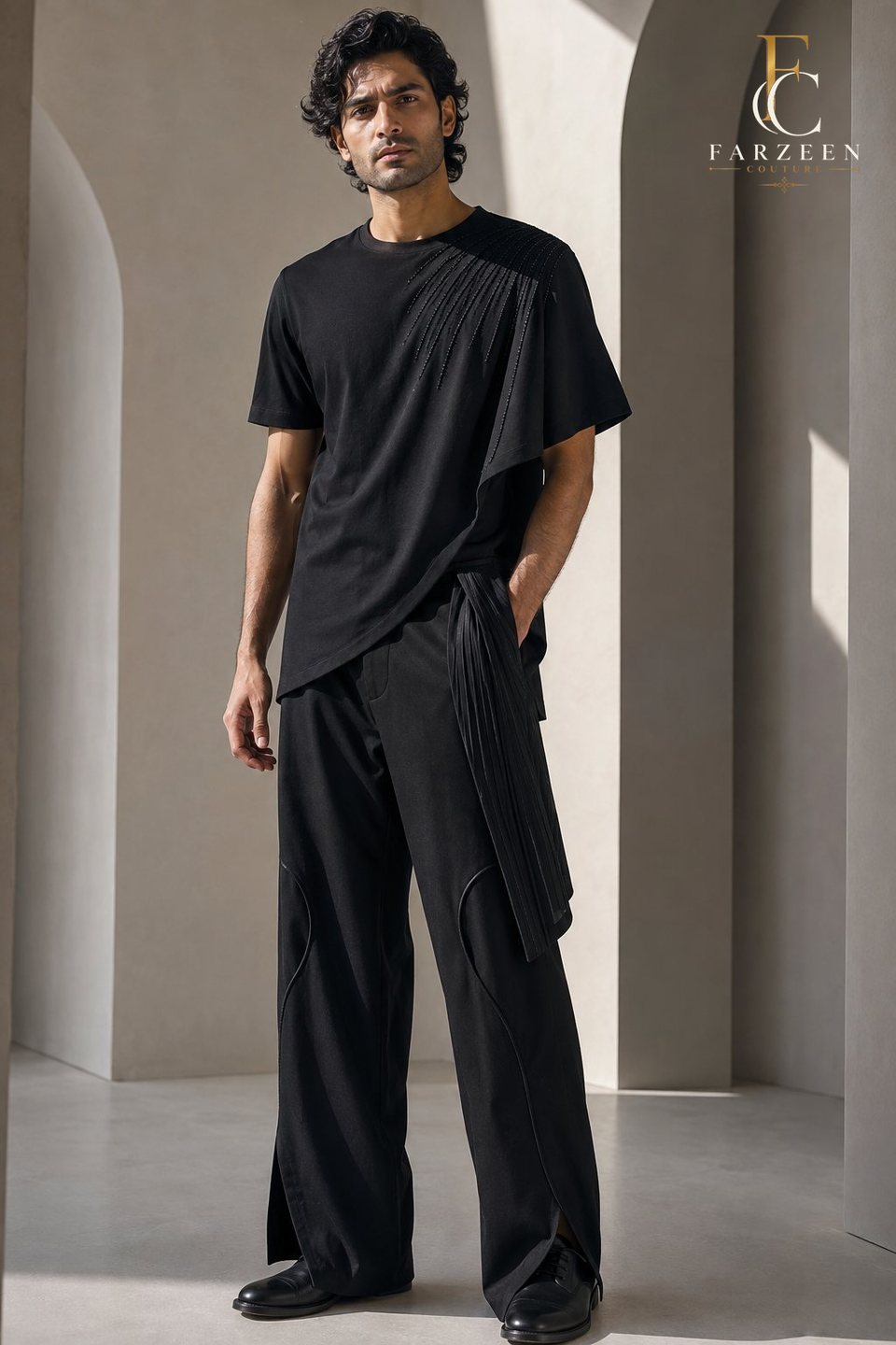Man in a draped black T-shirt and wide black trousers