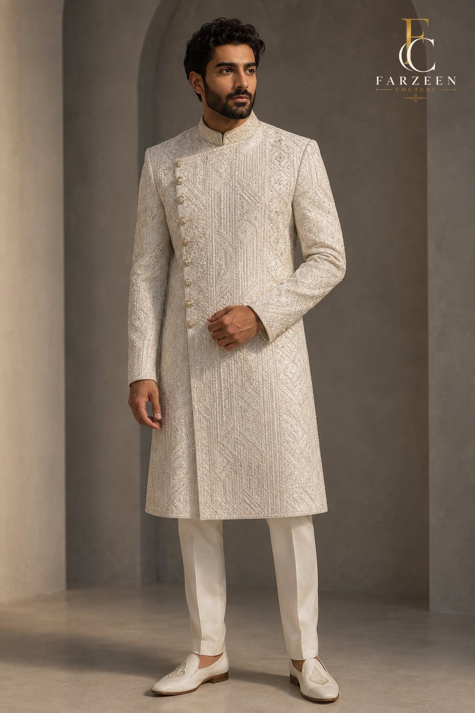 Groom in a pearl-white silk achkan with geometric pearl and silver embroidery